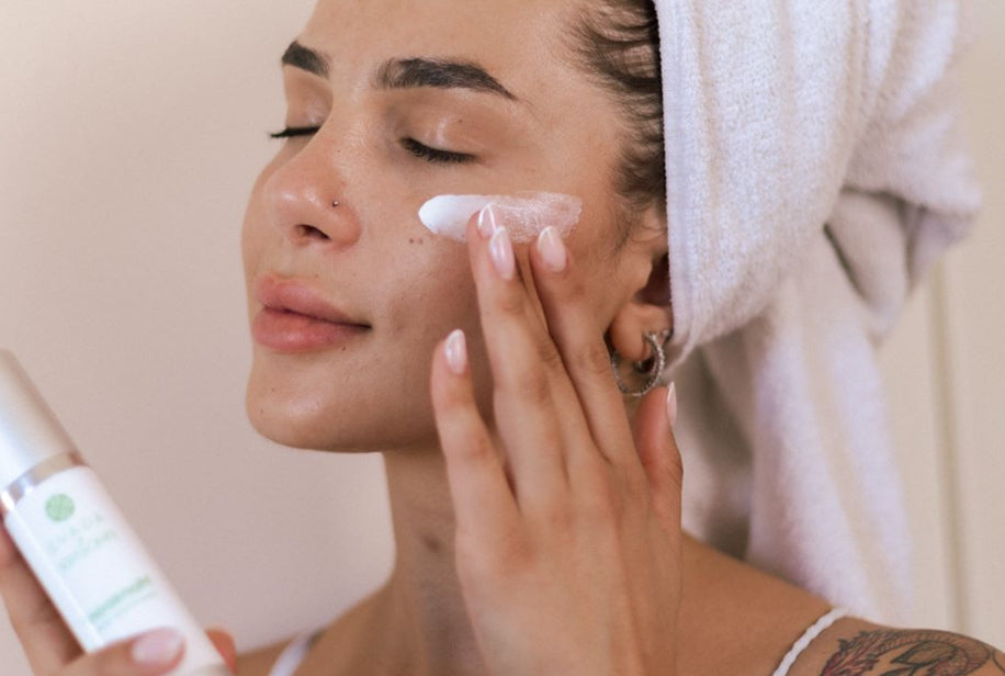 Model applying Monsoon Advanced Moisturizer — rich hydration and anti-aging care for soft, smooth skin.